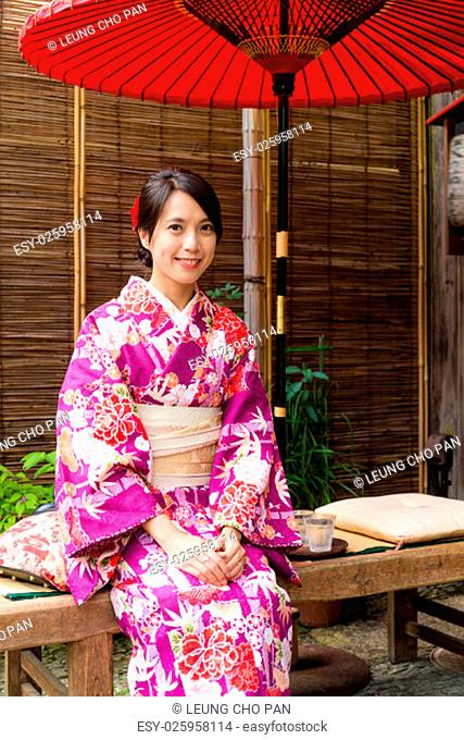 Japanese woman relaxing in tea house with kimono