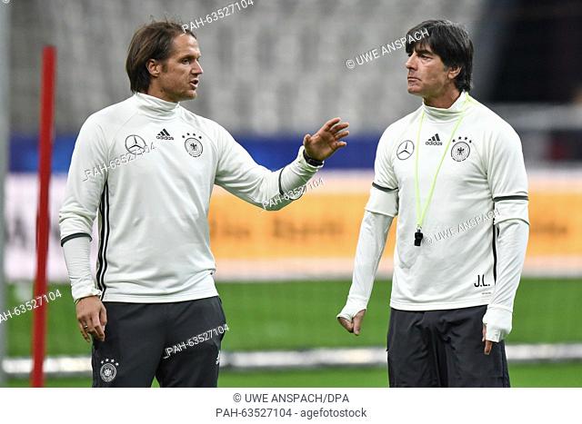 German head coach Joachim Loew (r) and his assistant Thomas Schneider talk during a training session of the German team before the international friendly soccer...