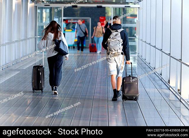 18 July 2023, Hesse, Cologne: Travelers walk through the departure hall at Cologne/Bonn Airport. The Federal Statistical Office announces the figures for the...