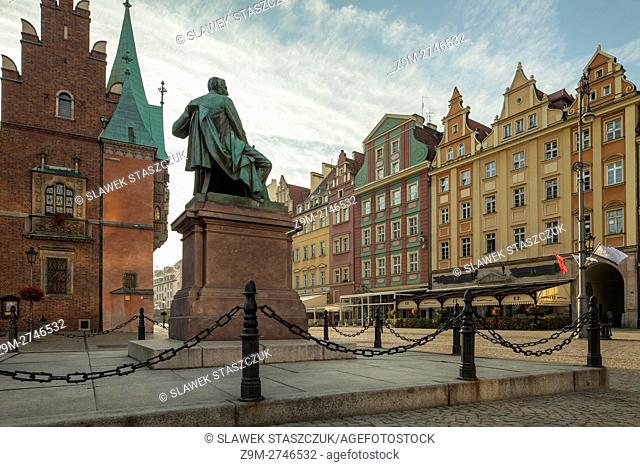 Autumn morning at Aleksander Fredro monument, old town square in Wroclaw, Lower Silesia, Poland