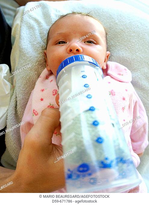 1 month old baby girl, being bottle fed