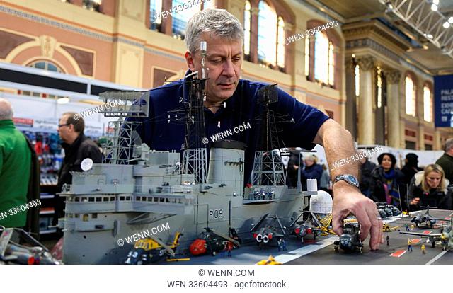 Dave Fortey puts together the finishing touches to his HMS Ark Royal (RO9) at the London Model Engineering Exhibition at Alexandra Palace today (19Jan18)