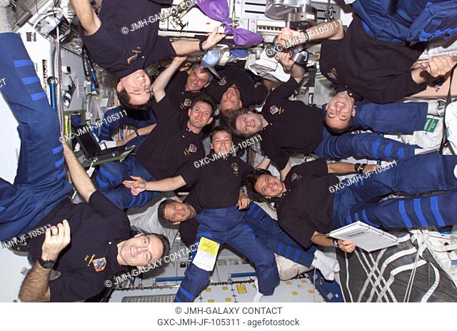The Expedition Four, STS-111, and Expedition Five crews assemble for a group photo in the Unity node on the International Space Station (ISS)