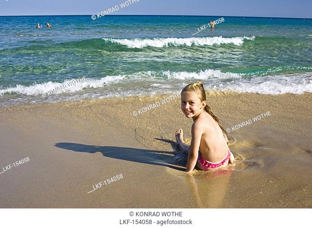 little girl playing at the beach, Sardinia, Italy