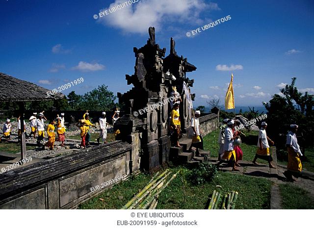 Procession of mourners leaving cremation ceremony in temple grounds. Besakih temple is situated on Mount Agung and known as the ‘Mother Temple of Bali