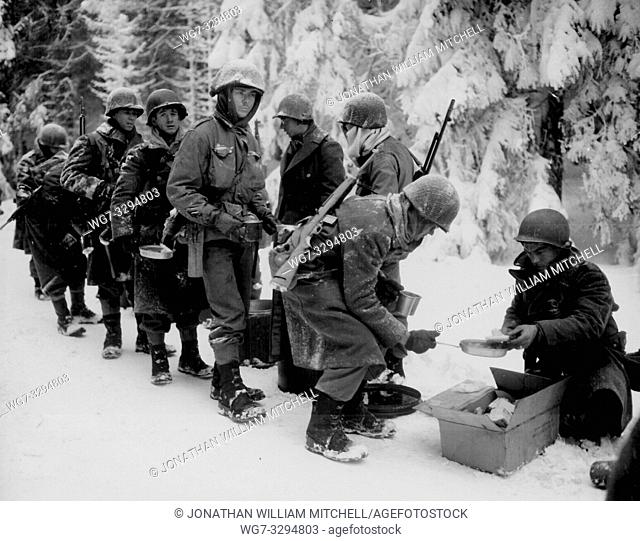 BELGIUM Near La Roche -- 13 Jan 1945 -- Chow is served to American Infantrymen of the 347th Infantry Regiment on their way to La Roche, Belgium
