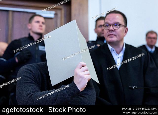PRODUCTION - 19 December 2023, North Rhine-Westphalia, Dortmund: The accused police officer who fired the shots is sitting next to his lawyer in the courtroom...