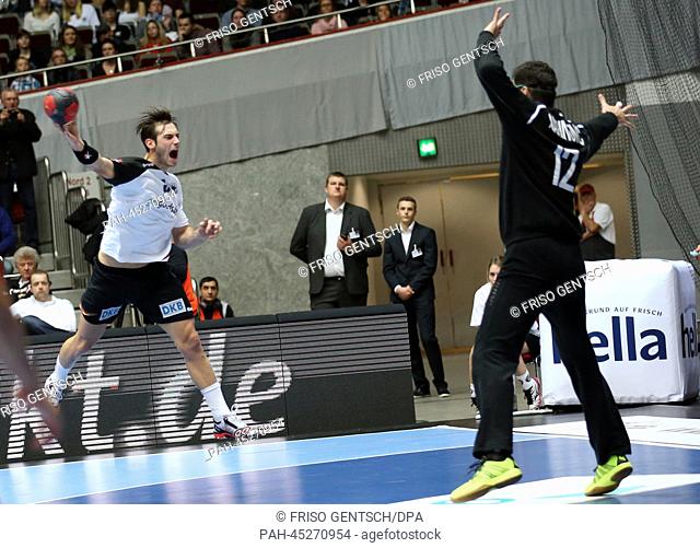 Germany's Uwe Gensheimer (L) in action against Austria's Nikola Marinovic (R) during the Four Nations Tournament handball match between Germany and Austria at...