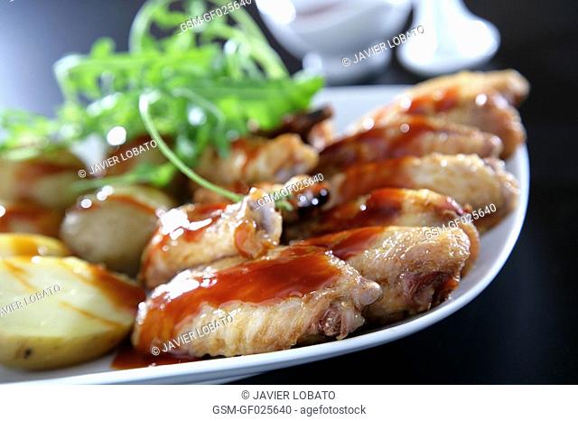 Chicken wings with roast potatoes and barbecue sauce