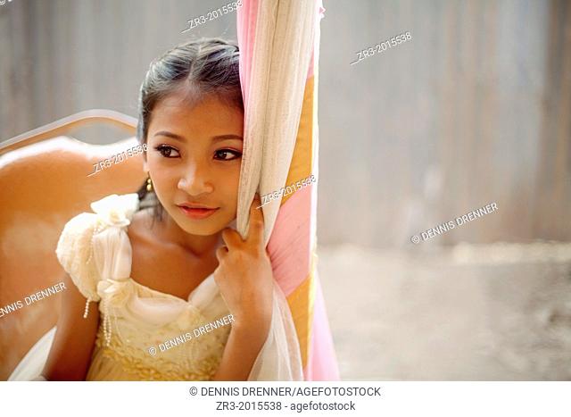 Portrait of a young girl dressed up for a small village outside of Phnom Penh, Cambodia