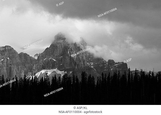 Panoramic view of a mountain peak enveloped in clouds, Rocky Mountains, Canada black and white