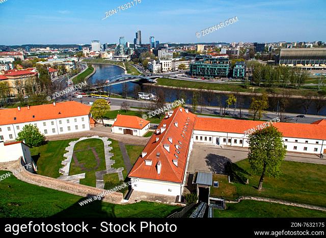 View of Vilnius city in Lithuania, with historical architectural structures, buildings around, with a flowing river, on blue clear sky background