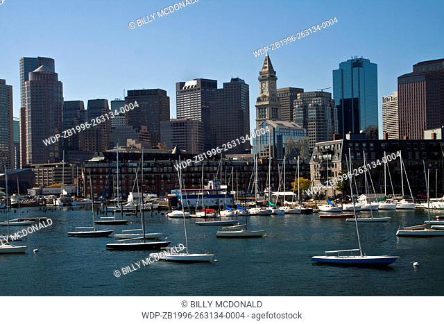 Sailboats Moored In Boston Harbor With The Custom House Tower In The Distance, Boston, Massachusetts, USA