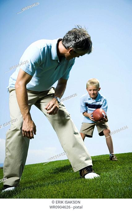 Man playing football with his son