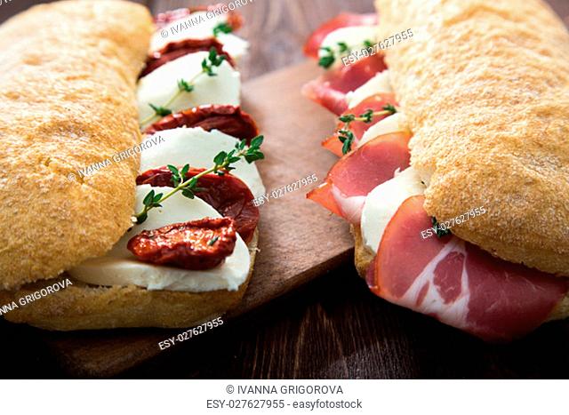 assorted sandwiches. sandwich Caprese with mozzarella and sun-dried tomatoes and ciabatta with ham