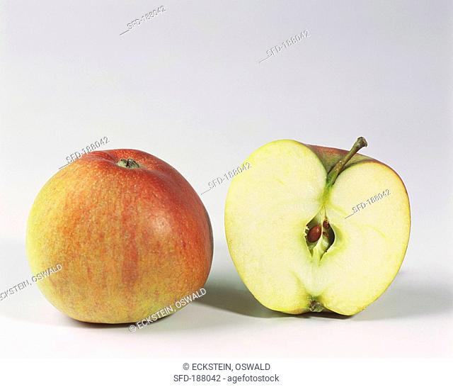 One half and one whole Braeburn apple