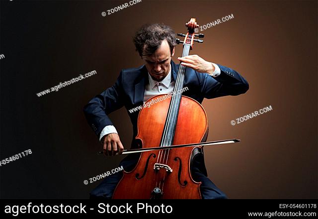 Lonely cellist composing on cello with nothing around