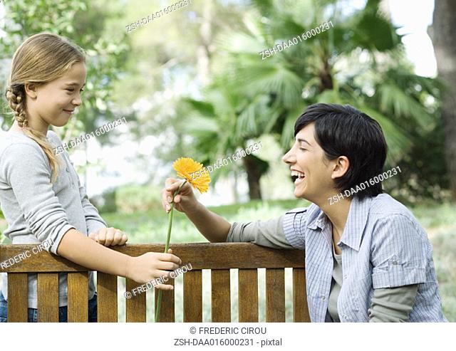 Mother and daughter, exchanging flower