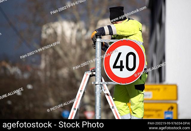 19 February 2020, Baden-Wuerttemberg, Stuttgart: An employee of the city mounts a speed 40 sign. Many other roads in Stuttgart will be subject to a speed limit...