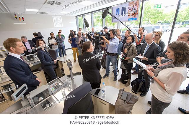Representatives of Aldi-Sued (l) with members of the press at the redesigned Aldi supermarket is presented in Unterhaching near Munich, Germany, 11 May 2016