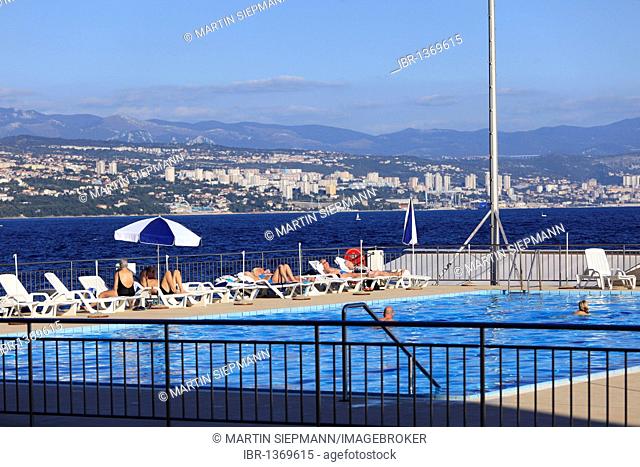 Swimming pool in Opatija in front of the city Rijeka with the Gorski Kotar Mountains in the distance, Istria, Croatia, Europe