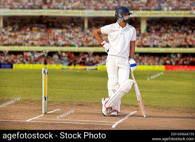 Batsman waiting at the non striker's end in the Cricket ground during a match
