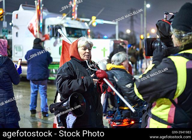 A protestor is interviewed by a main stream media television crew on 11 February 2022, day five, at the Freedom Convoy blockade of the Ambassador Bridge in...