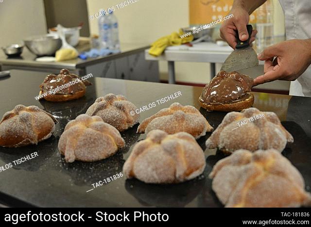 MEXICO CITY, MEXICO - OCTOBER 15: Chef Raul Linares owner of the 'Concheria' bakery, decorates the Pan de muerto (bread of the dead)