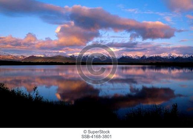 Usa, Alaska, Denali National Park, Alaska Range Reflecting In Pond, Mt. Mckinley In Clouds