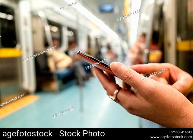 using smartphone at the MRT carriage with copyspace