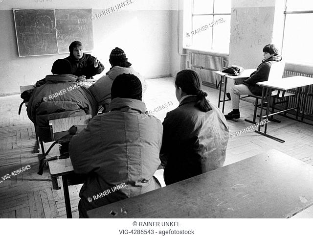GEORGIA, TBILISI, 12.02.1994, GEO , GEORGIA : In a high school in Tbilisi a teacher and her pupils are protecting themselves from the cold with thick jackets