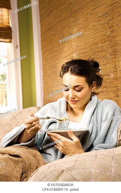 Young Woman Eating Soup