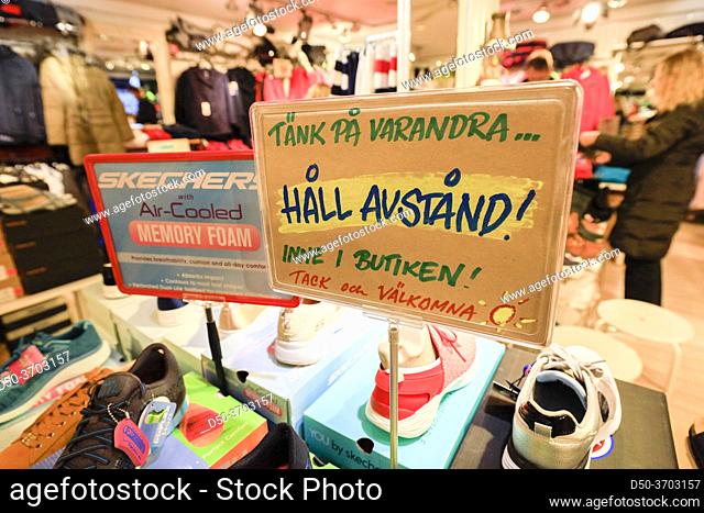 Stockholm, Sweden A sign in a shoe store saying in Swedish: ""Think of others keep your distance, ""