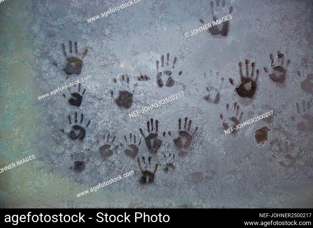 Hand imprints on frosty glass