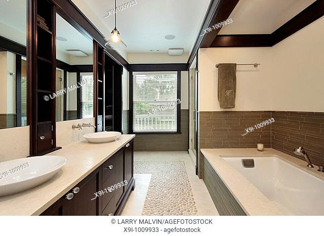 Master bath in luxury home with dark wood trim