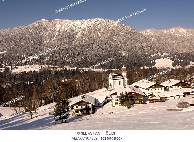 The snowy village Wamberg near Garmisch-Partenkirchen in winter. In the background the Wank