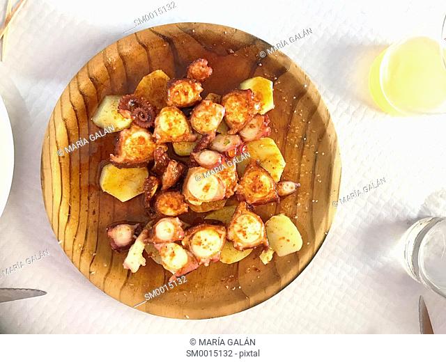 Octopus with potatoes serving, view grom above. Galicia, Spain