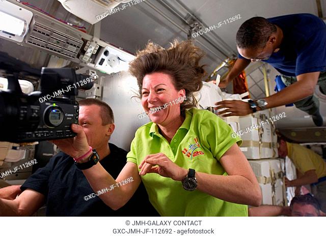 NASA astronauts Cady Coleman, Expedition 26 flight engineer; and Alvin Drew (top right), STS-133 mission specialist; along with Russian cosmonaut Dmitry...