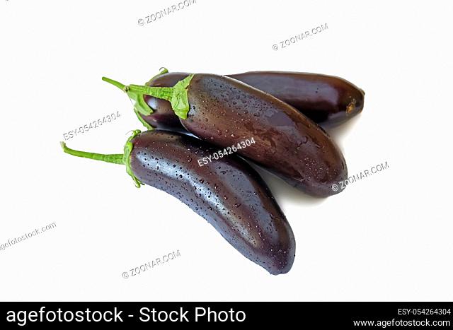 Three ripe eggplant. Presented on a white background