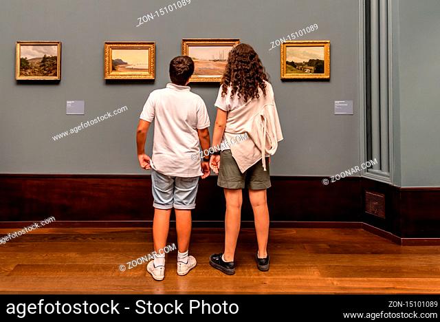 Hamburg, Germany - August 4, 2019: Teenagers looking at painting in Hamburger Kunsthalle museum