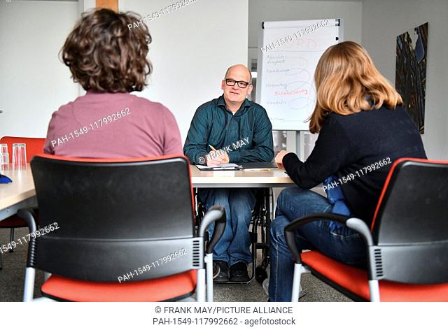 A wheelchair user at his workplace, Germany, city of Hamburg, 05. March 2019. Photo: Frank May (model released) | usage worldwide