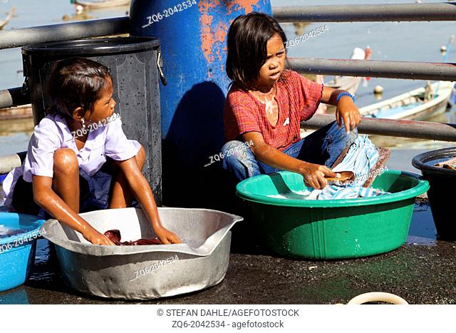 Little Sea Gypsy Girls doing the Laundry on Rawai Beach on Phuket, Thailand