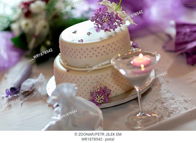 Traditional wedding cake with purple flowers