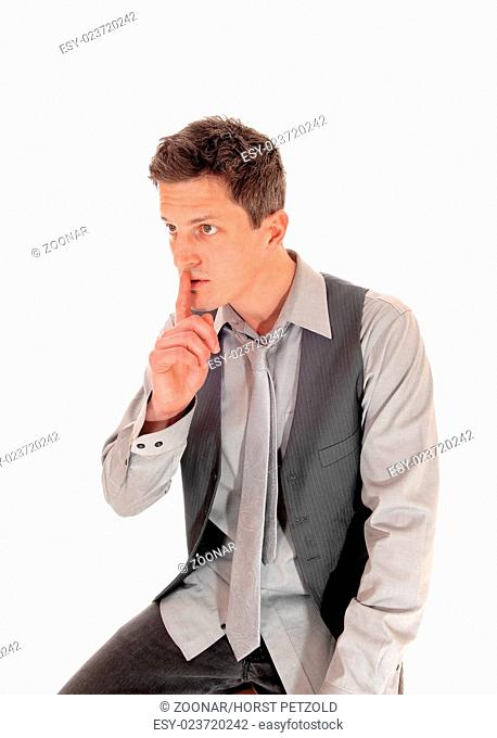 Man with finger over mouth