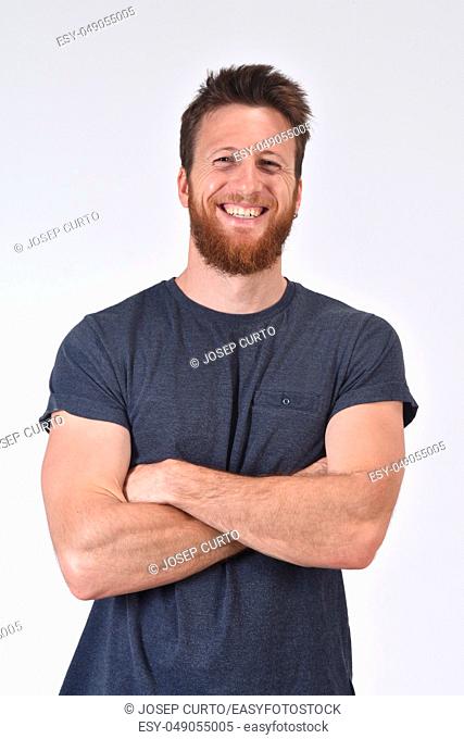 portrait of a smiling man with arms crossed on white background