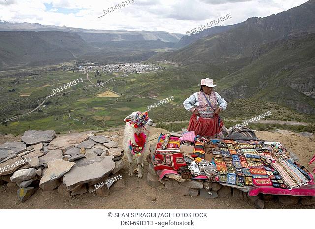 Woman selling tourist souvenirs above Yanque, Colca Canyon, Peru