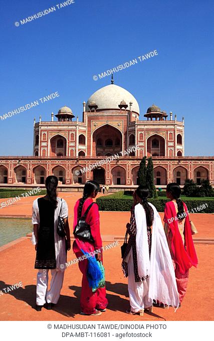 Indian girls watching Humayun's tomb built in 1570 made from red sandstone and white marble first garden-tomb on Indian subcontinent persian influence in mughal...