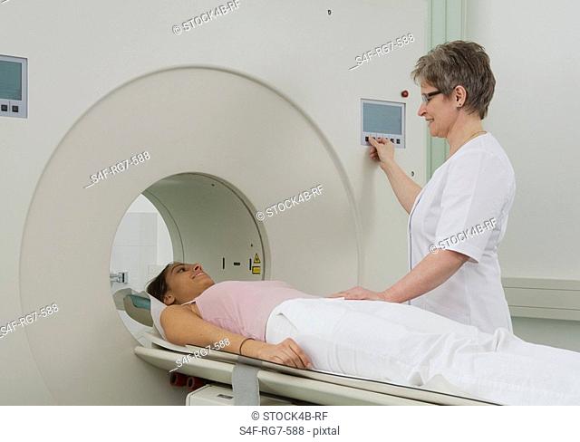 Nurse and patient at CT scanner