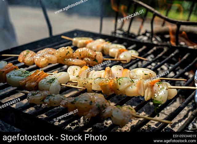 Fish skewers with shrimp and squid on the grill