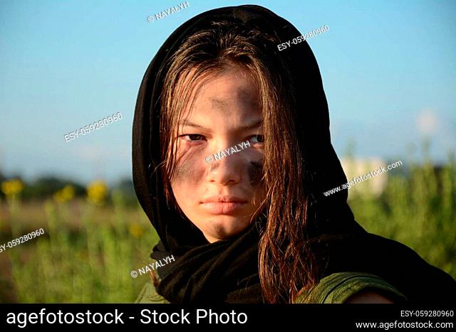 A portrait of a teenage girl militia soldier in a post apocalyptic desert wasteland. Urban combat and wasteland